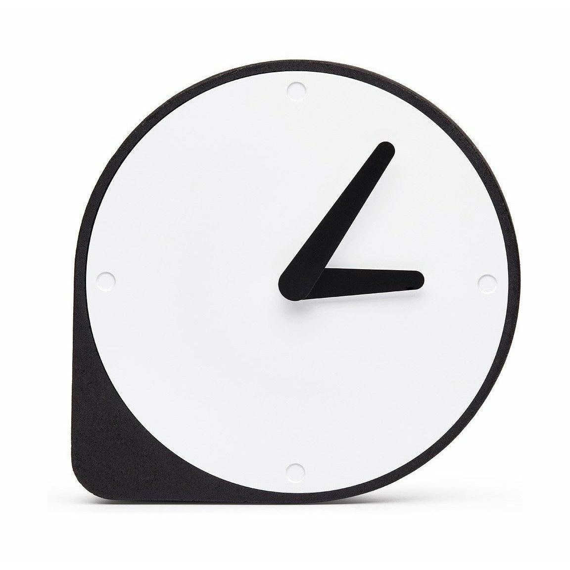 A Puik Clork table clock with an asymmetrical shape, sitting on a white surface.